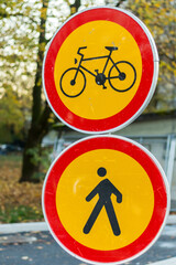 traffic signs for bicycle and pedestrian path in autumn setting