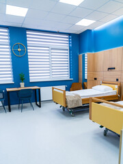 Bright medical ward with modern beds. Bright medical ward featuring modern beds and blue decor for patient comfort.