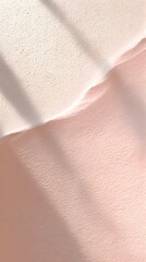 Minimalist abstract pastel pink and cream textured background with soft light and shadow patterns evoking a calm and airy mood