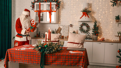 Santa Claus in a festive kitchen preparing for Christmas