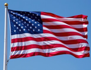 Waving American Flag Against a Clear Blue Sky Symbolizing National Pride and Patriotism