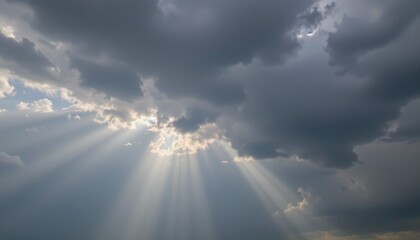 Dramatic Sky with Sun Rays Breaking Through Dark Clouds Creating a Serene Atmosphere