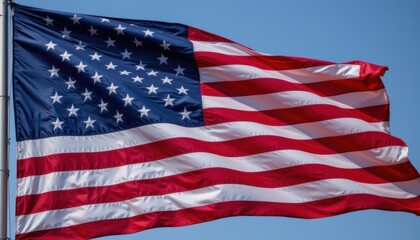 Waving American Flag Against Clear Blue Sky Symbolizing National Pride and Unity