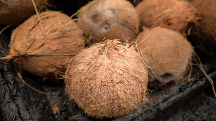 Coconuts in market basket close-up.