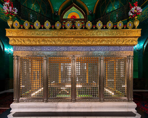 Ukeyma Khanum's Tomb, Bibi-Heybat Mosque, Baku, Azerbaijan. Golden and silver shrine with intricate Islamic calligraphy, vibrant green tiles, and a beautiful stained glass window.