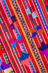 Colorful piece of Guatemalan fabric with a pattern of stars and flowers