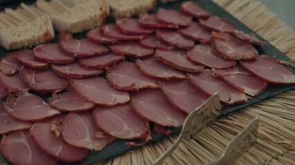 arranged cured meat slices displayed on rustic slate platter
