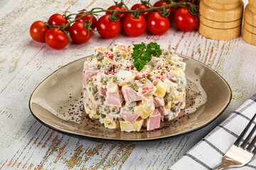 Russian traditional Olivier salad with sausages