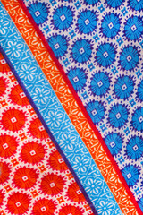 Colorful piece of fabric with a blue stripe and orange and red stripes