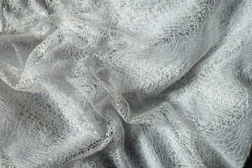 Soft folds on pure white web like lacy fabric