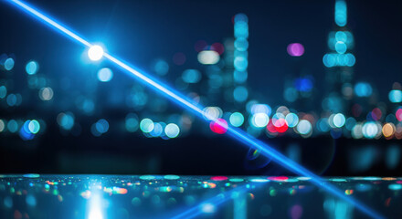 Futuristic urban night scene with glowing blue laser beam and city lights bokeh background