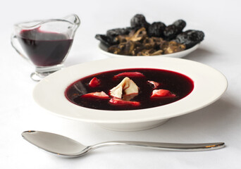 Christmas beetroot soup (borscht) with dumplings, mushrooms and dried plums