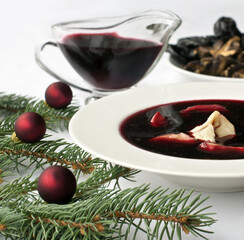 Christmas beetroot soup (borscht) with dumplings, mushrooms and dried plums