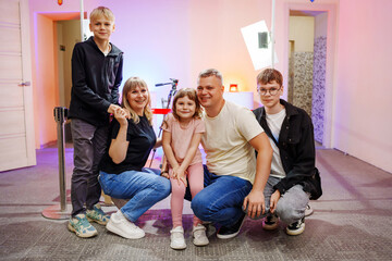 Family gathering in a colorful photo studio setting