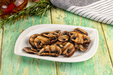 Tasty hot grilled champignon mushrooms