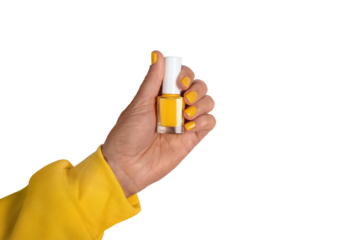 Close-up of a hand in a yellow sleeve holding a yellow nail polish bottle with matching polished nails on transparent background.