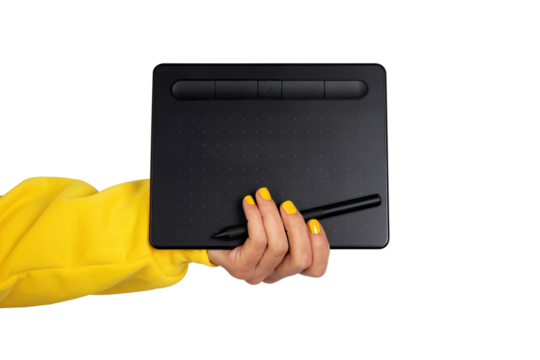 Female hand in yellow sleeve holding a black digital drawing tablet and stylus on transparent background. Modern creative technology concept.
