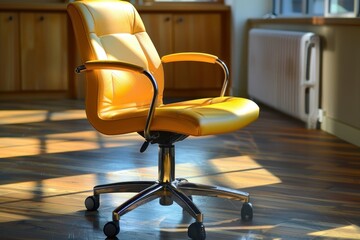 Comfortable yellow office chair basking in sunlight in an empty room