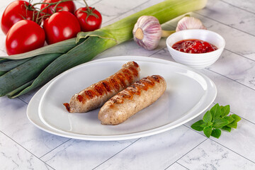 Grilled pork sausages served tomato sauce