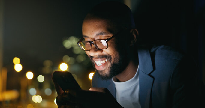 Texting, night and black man in city with phone, bokeh and funny chat on social media. Happy, glasses and male person on balcony with tech, online communication or meme post in evening message.
