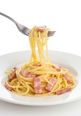 A fork lifting delicious spaghetti carbonara from a white plate.