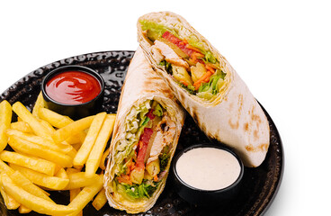 Delicious wrap with fries served on a black plate in a casual setting