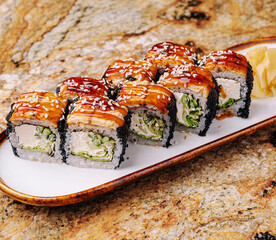 Delicious sushi rolls displayed on a wooden plate with garnish