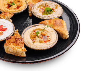 Delicious hummus and pita served on a black plate