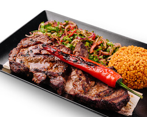 Grilled steak with spicy pepper and flavorful sides served on a plate
