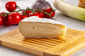 Soft camembert cheese over board