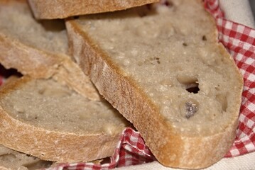 Slices of rustic bread with crust and red napkin