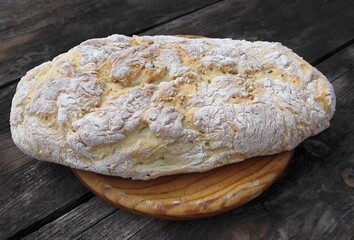 Homemade artisan ciabatta bread on rustic wooden table