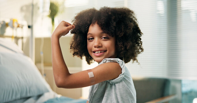 Happy boy, portrait and arm with band aid for vaccine, flu shot or immunity in hospital. Child, kid or youth with smile, flex or plaster for medical vaccination, healthcare visit or cure in clinic