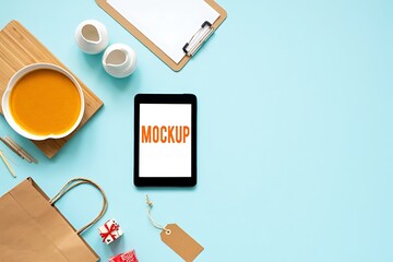Flat lay of a smartphone mockup with soup and shopping bag on blue background