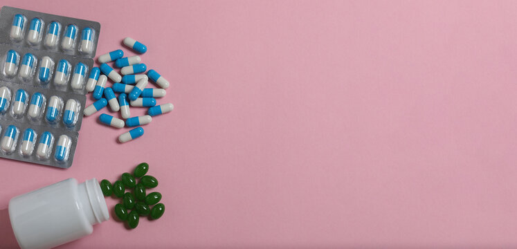 Pills in blister packs on a color background, banner
