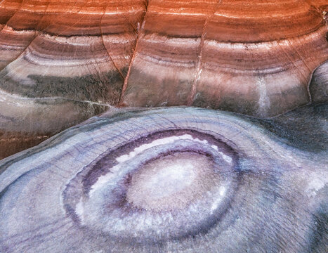 Aerial view of layered rock formations with vibrant hues create a mesmerizing landscape, Hanksville, Utah, United States.