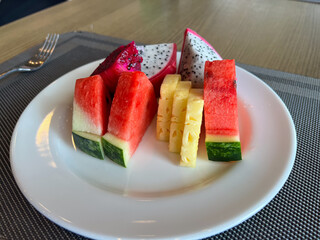 Fresh Assorted Fruit Plate with Watermelon, Pineapple, and Dragon Fruit on White Dish