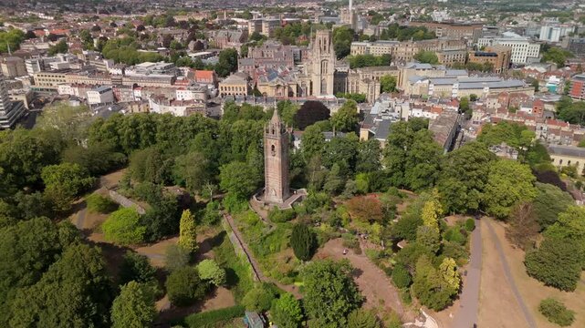 Bristol UK: 28th July 2025: Breathtaking drone view of Cabot Tower surrounded by lush greenery of Brandon Hill park. With University of Law in background