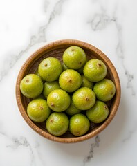 “Amla Fruits in Wooden Bowl on White Background”. amla fruit
