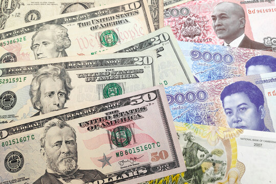 Stack of US Dollar and Cambodian rie