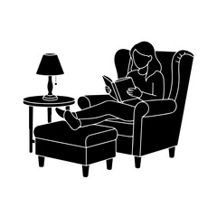 Silhouette of a woman relaxing in a wingback armchair reading a book with feet up on ottoman.