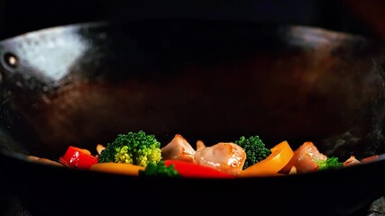 Exciting wok cooking with chicken and colorful vegetables stir-fried with intense flames - Powered by Adobe