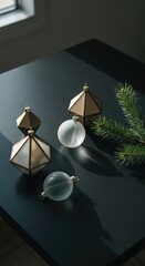 Ornaments and a pine branch on a dark surface creating a christmas or holiday themed scene