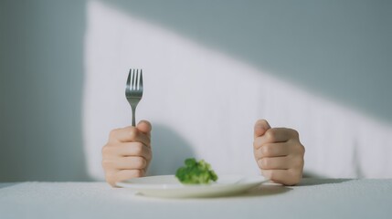 Hands of the invisible person hold a fork and eating broccoli on a white plate. Diet. Nutrition
