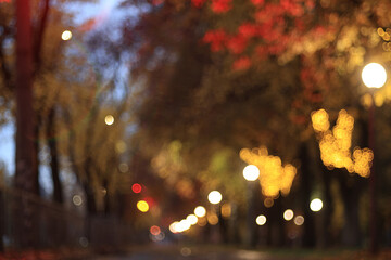 Evening in an autumn park, abstract blurred background, changing seasons in the city