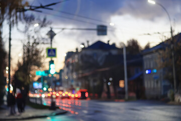 Night city blurred background, bokeh in autumn city traffic cars