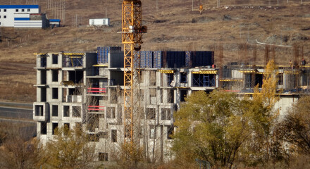 Apartment building under construction. Residential building. Urban grunge. New residential area. Construction site. Construction crane. Ust-Kamenogorsk (kazakhstan)