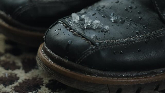 Melting snow on boot evokes transition from winter to spring outdoors