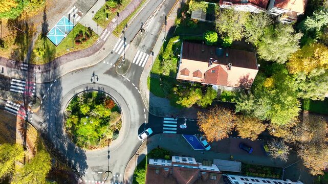 Top-down drone shot of Sopot roundabout with cars and pedestrian crossings.
