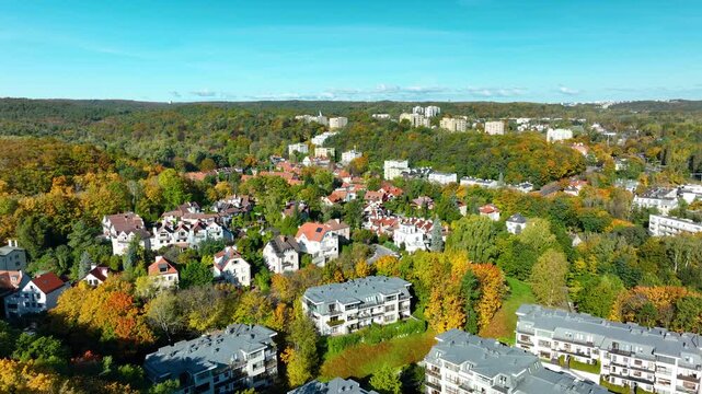 Bright aerial view of Sopot homes and autumn foliage.